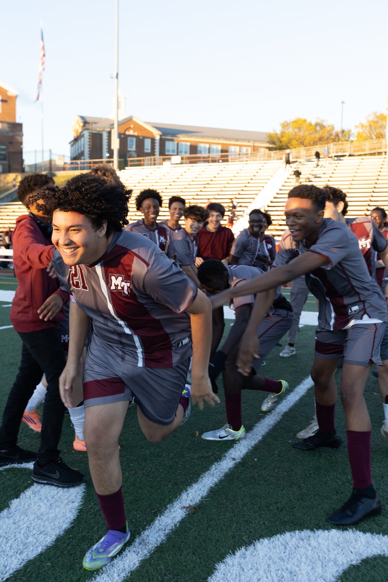 Soccer players celebrating and running downfield